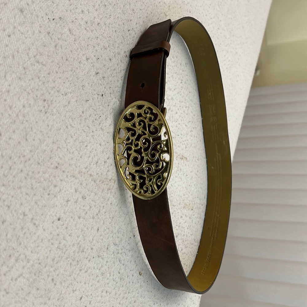 Liz Claiborne brown leather belt with a gold ornate buckle.